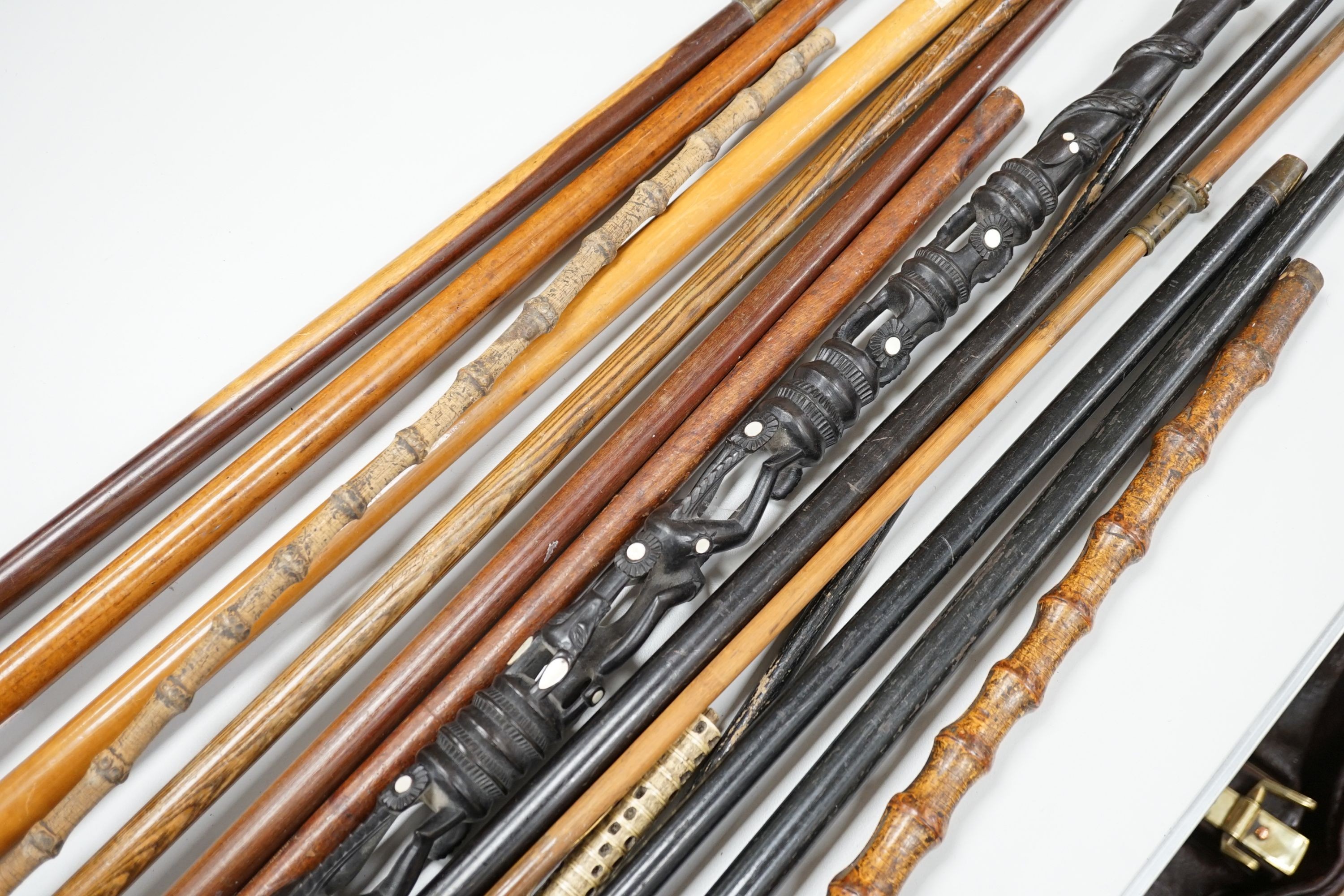 A collection of fifteen assorted walking sticks and canes, many silver mounted